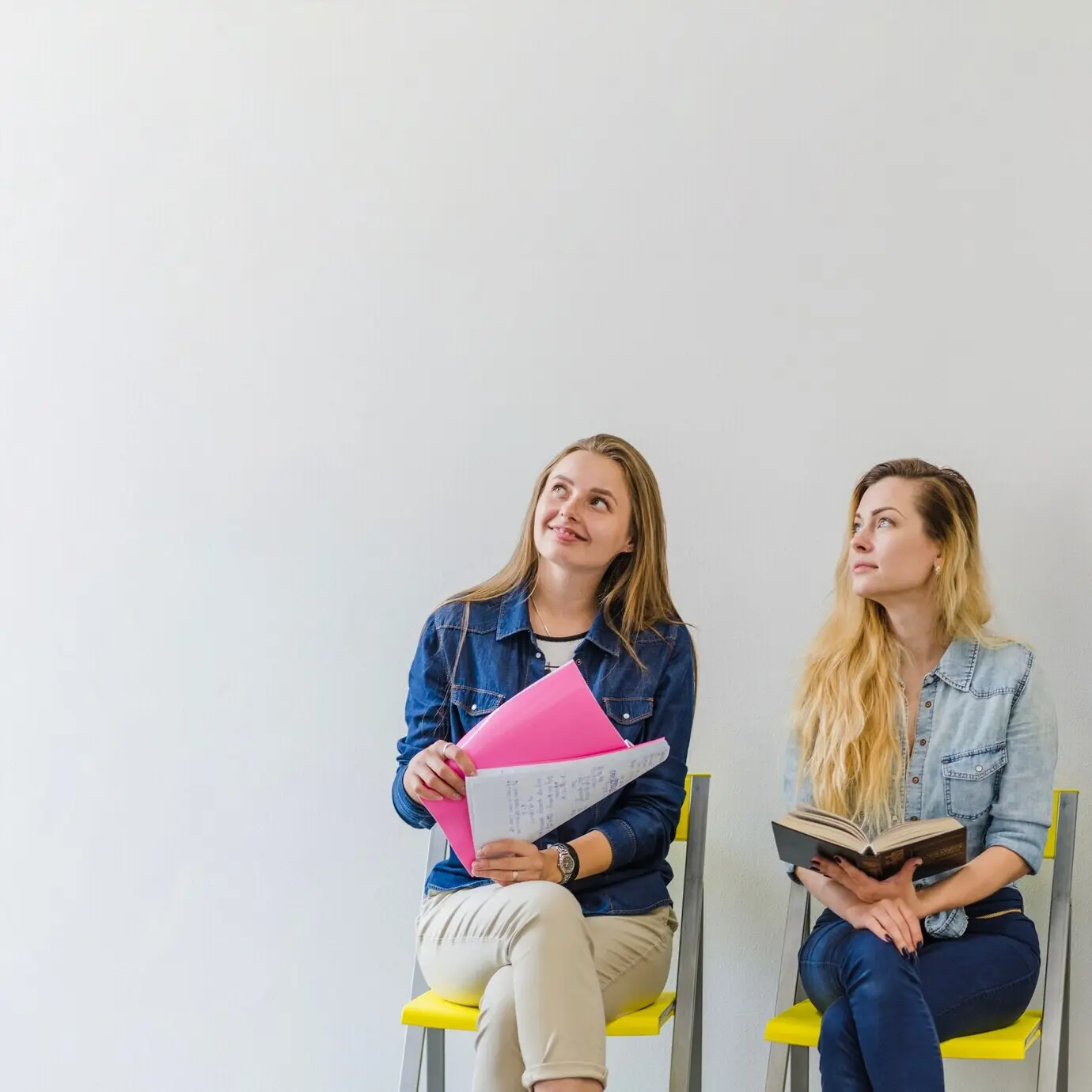 Young women with books are listening.